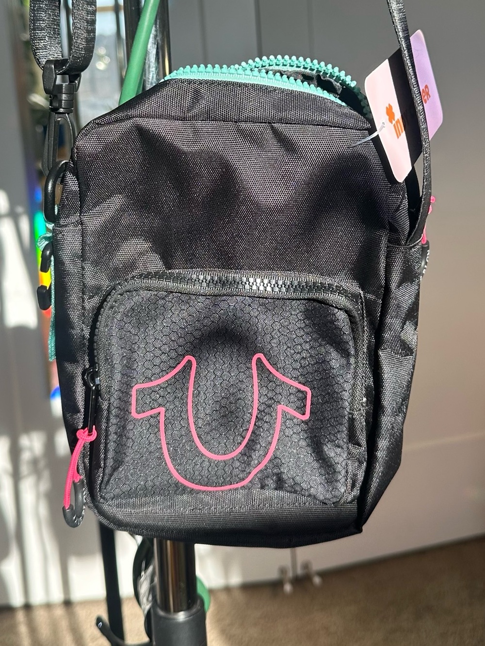 True Religion Black Crossbody Bag with Pink Logo and Teal Zipper